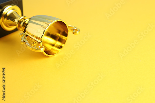 Champion golden trophy on yellow background