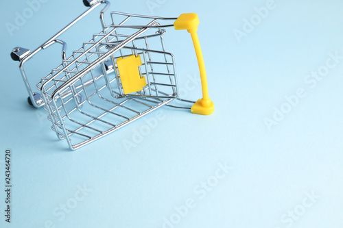 Shopping cart on blue background. Business concept