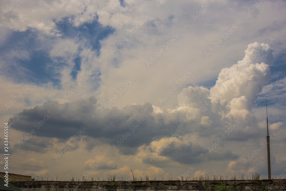 Summer cloudy sky before the rain. The terrain in southern Europe. Sunset over the city. Fantastic view over the planet Summer cloudy sky before the rain. The terrain in southern Europe. Sunset over the city. Fantastic view over the planet