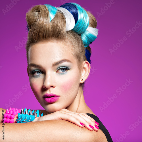 Fashion model with bright makeup and creative hairstyle