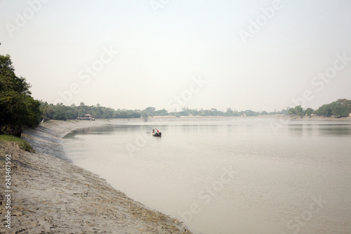 Some fishermen on a boat in Sundarbans, India photo