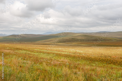 Mongolian steppe on the background of a cloudy sky