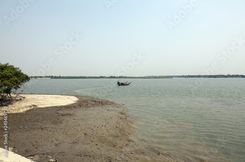 Traditional fishing boat in the delta of the Ganges River in Sundarbans Jungle National Park in India