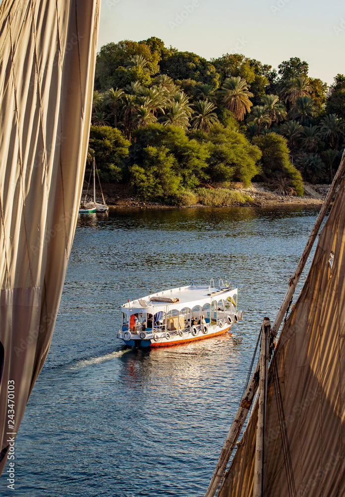 Naklejka premium Nile river tourist boat at sunset in Luxor Egypt
