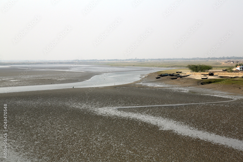Mud beds on the river Malta during low tide the water in the Canning Town, India Mud beds on the river Malta during low tide the water in the Canning Town, India