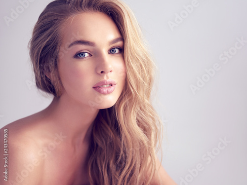 Young blond woman with long curly hair.