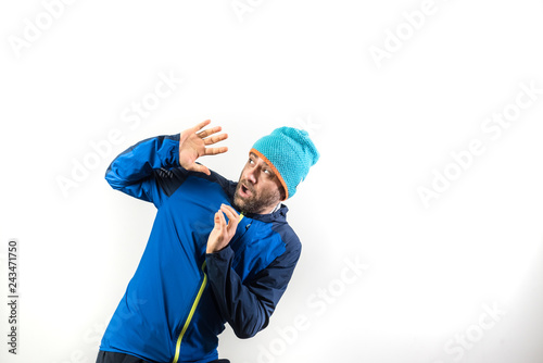 Portrait of male mountaineer in winter with danger expression, studio with isolated white background