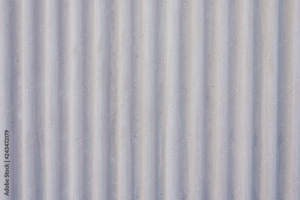 Wavy metal background on a gray wall. Wavy metal background on a gray wall.