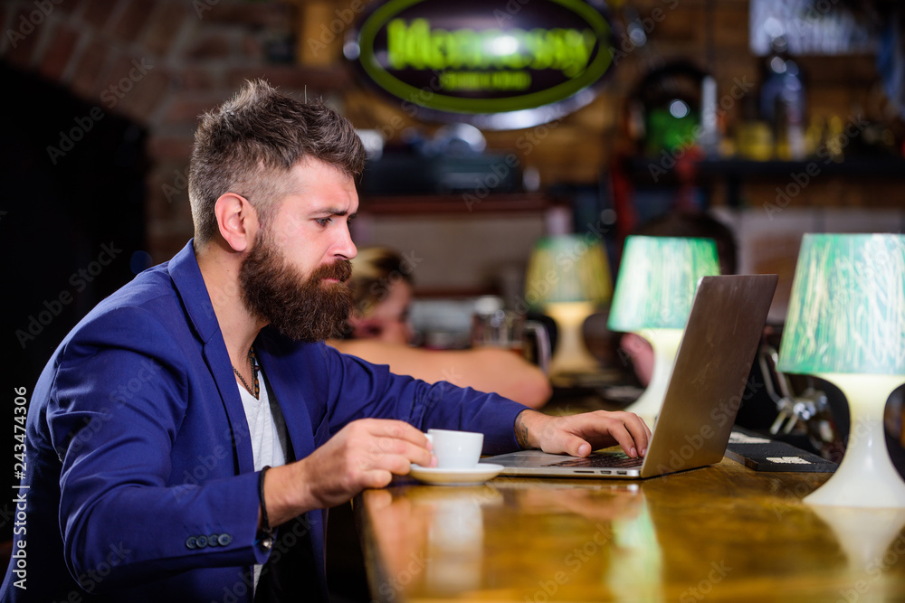Man bearded businessman sit pub with laptop and cup of coffee. Manager work online while enjoy coffee. Online job. Hipster freelancer work online blog notebook. Surfing internet. Freelance benefit Man bearded businessman sit pub with laptop and cup of coffee. Manager work online while enjoy coffee. Online job. Hipster freelancer work online blog notebook. Surfing internet. Freelance benefit