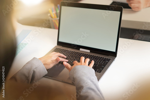 Close up of womans' hands typing on computer in offcie setting