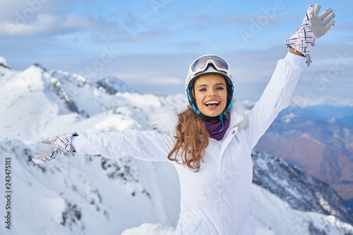 Woman Skier Standing at Snow Looking at Camera. Winter Montain background
