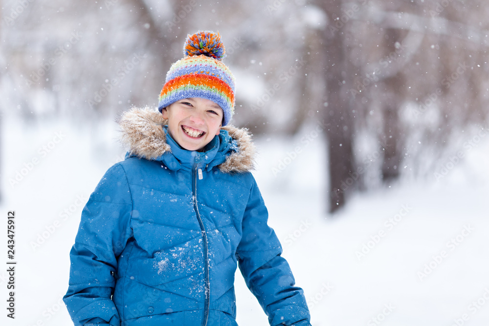 Portrait of cheerful happy boy playing in winter park Portrait of cheerful happy boy playing in winter park