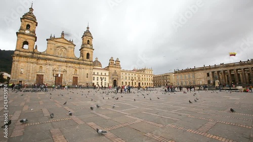 BOGOTA, COLOMBIA - JUNE 14: Unidentified people walk past the Archbishopric Cathedral of Bogota and the Capitolia Nacional in Bogota, Colombia on June 16, 2016. photo