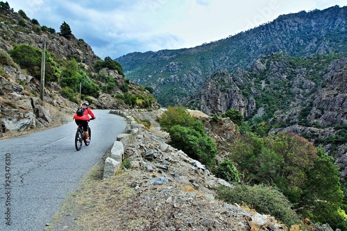 Corsica-cyclist in the canyon river Golo