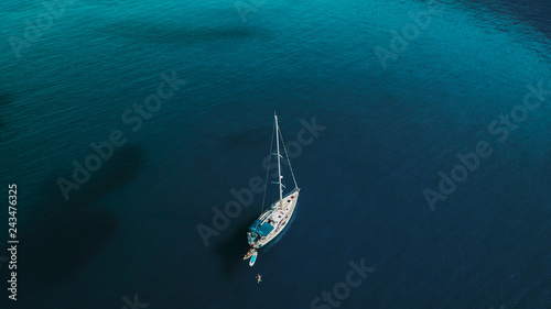 Aerial shot of beautiful blue lagoon at hot summer day with sailing boat. Top view. © dusanpetkovic1