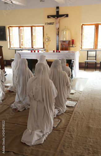 Sisters of Mother Teresa's Missionaries of Charity in prayer in the chapel of the Mother House, Kolkata, India  photo