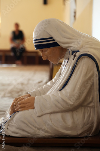The statue of Mother Teresa in the chapel of the Mother House, Kolkata, India. The statue was made in the pose in which the Mother prayed. photo