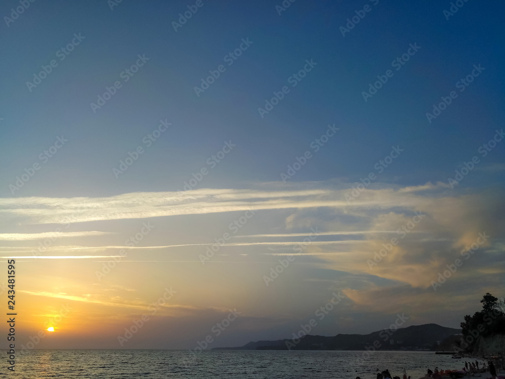 Amazing sea sunset on the pebble beach, the sun, waves, clouds Amazing sea sunset on the pebble beach, the sun, waves, clouds