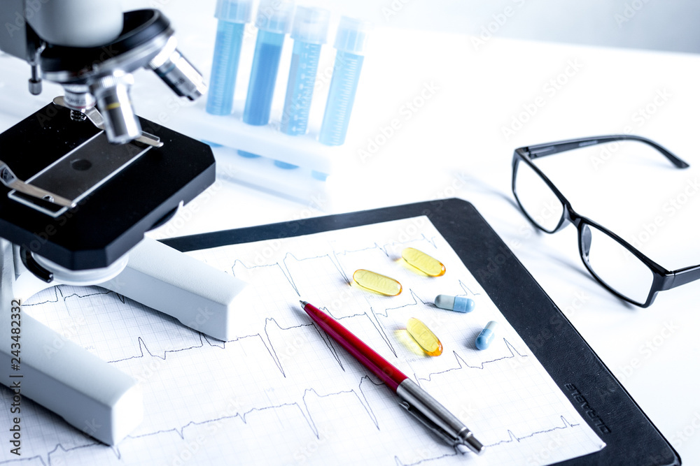 doctors desk with microscope and test tubes doctors desk with microscope and test tubes