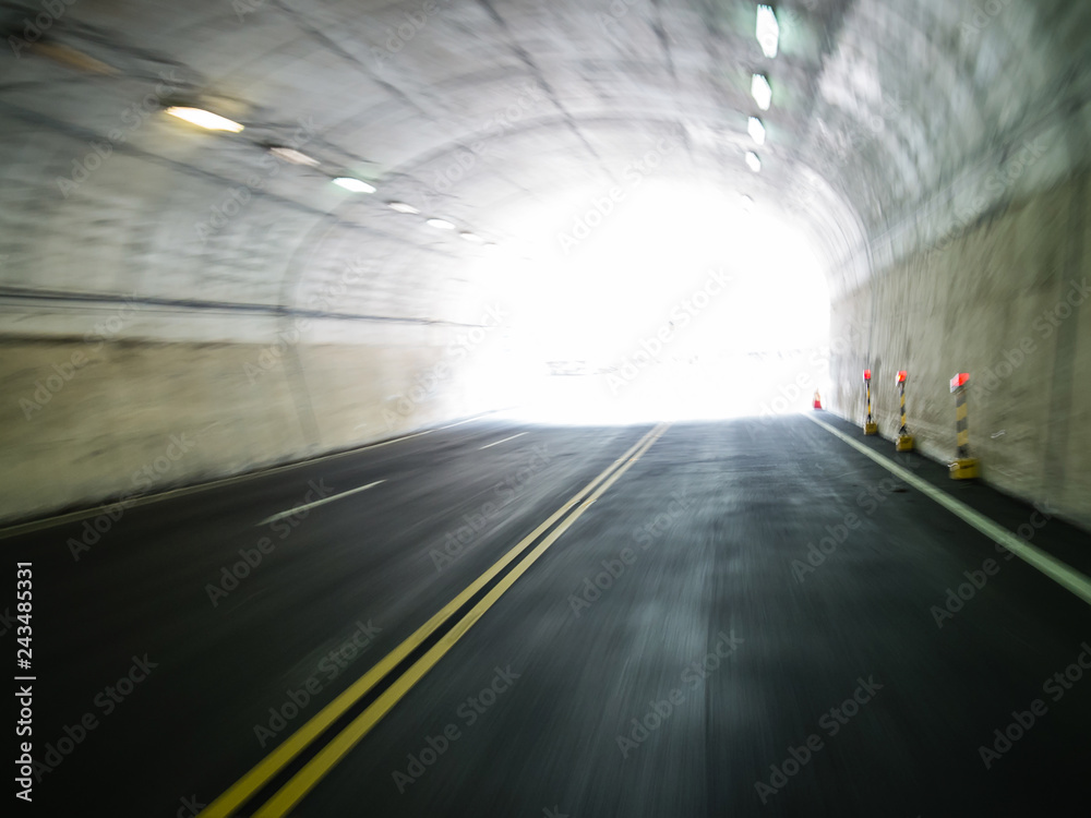 Tunnel exit background. Bright glowing light with motion blur.