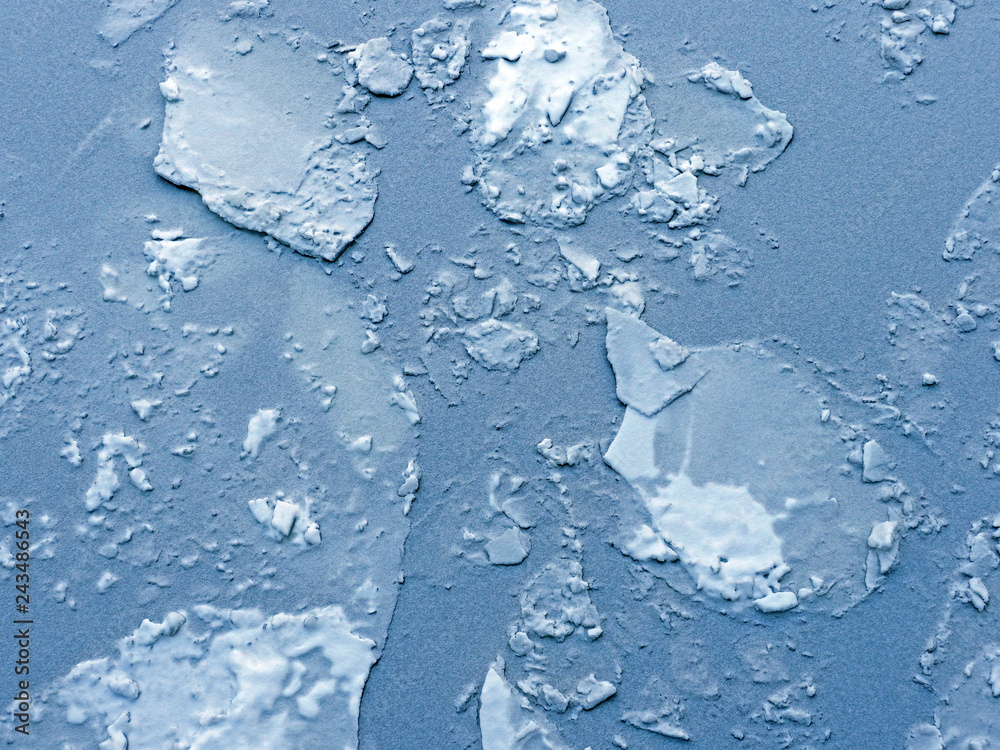 Glacier and iceberg landscape. Ice floes top view, nature winter background. Crack on an ice surface of the frozen water Glacier and iceberg landscape. Ice floes top view, nature winter background. Crack on an ice surface of the frozen water