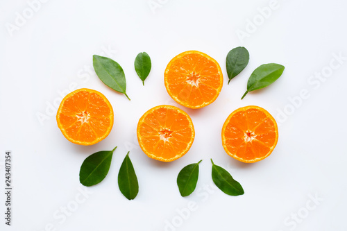 Orange fruits with leaves on white background.