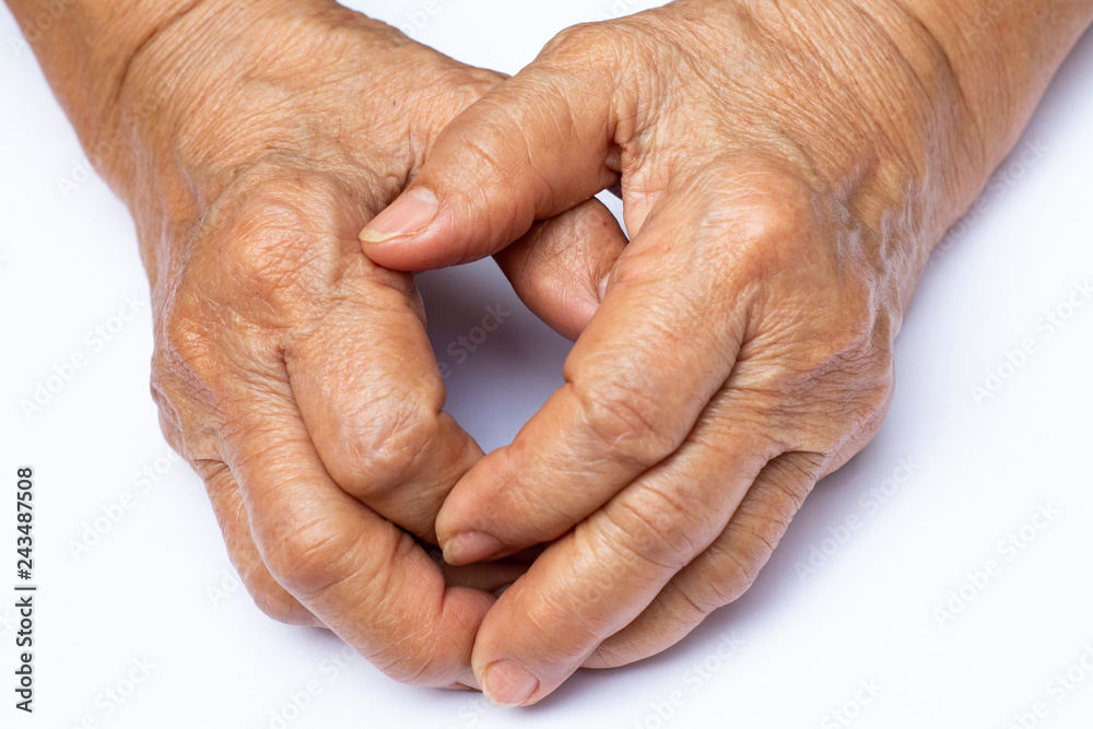Fototapeta premium Senior woman's grasping her hands, wrinkled skin texture of blood in back of the hands on white background , Close up & Macro shot, Selective focus, Body part, Healthcare concept