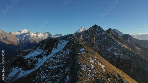 Flying the drone over austrian mountains. Snow already covered this mountains in october. photo