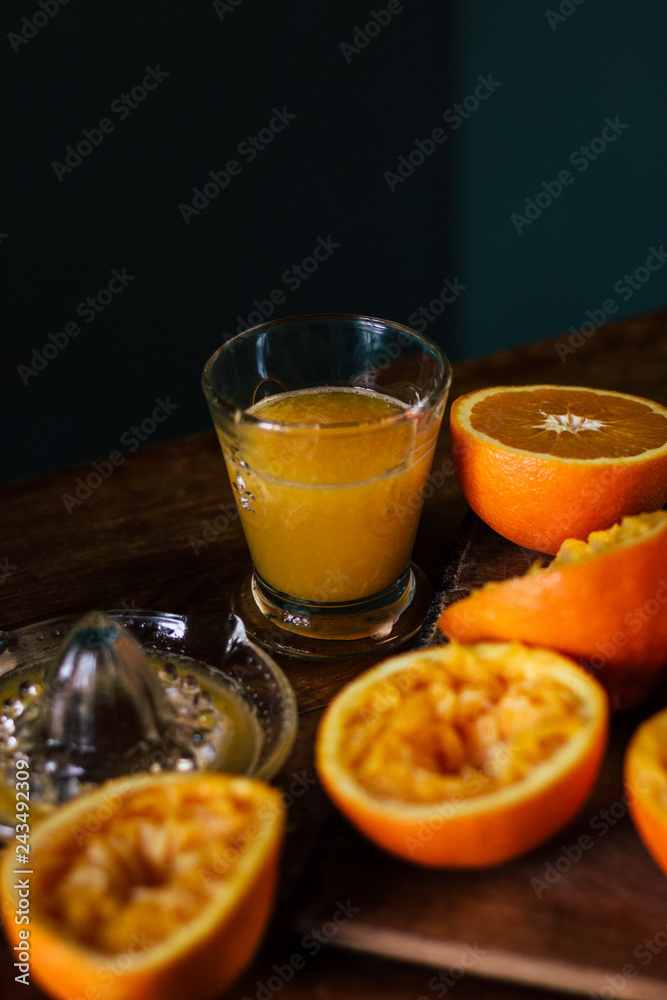 Oranges and squeezer on wooden table Oranges and squeezer on wooden table