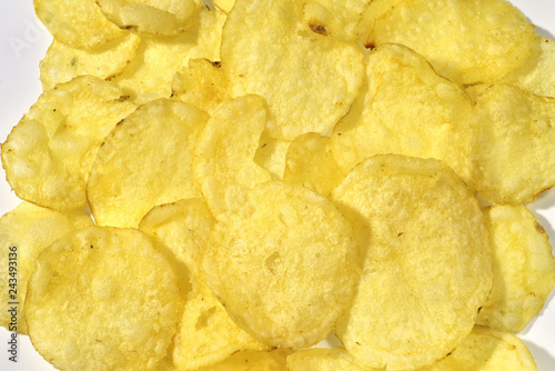 Potato chips on a white background, close-up food background, texture