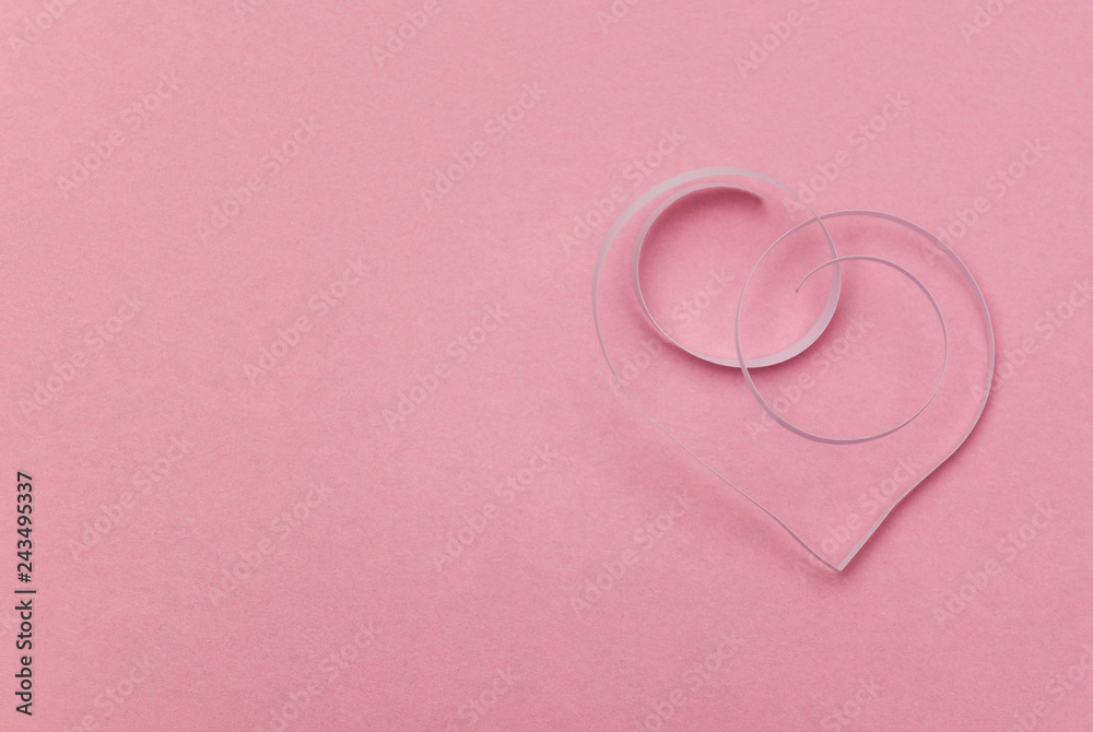 Paper ribbon heart on the pink background. Happy Valentines day. Copy space.