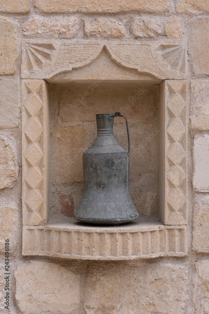 Antique metal copper utensils on stone wall in Turkey