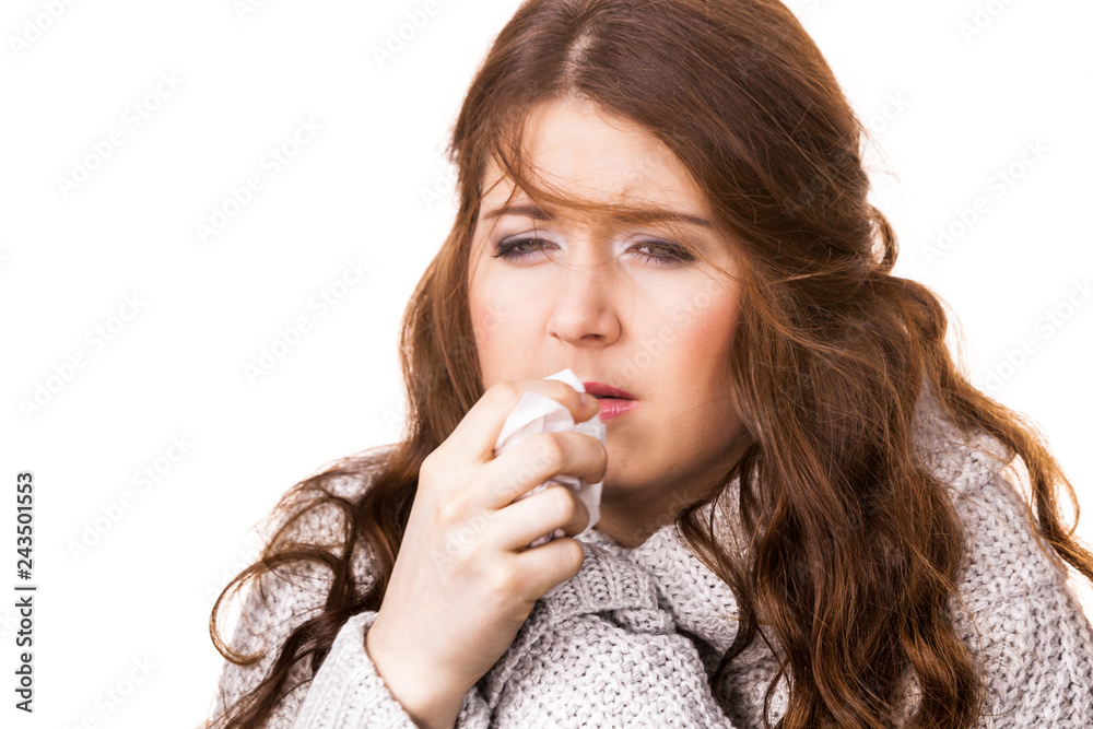 Sick freezing woman sneezing in tissue Sick freezing woman sneezing in tissue