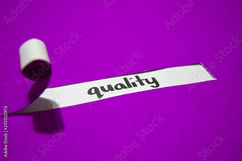 Quality text, Inspiration, Motivation and business concept on purple torn paper