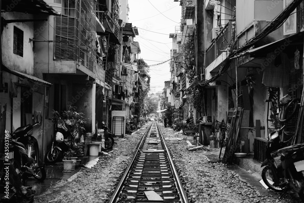 Hanoi Train Street. Vietnam city railway at rainy day. Famous tourist destination. Black and white filter