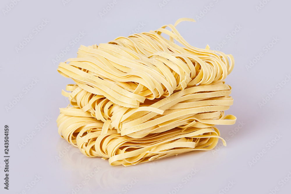Dry thick rolled noodles square shape. Capelli d'angelo, Angel's hair -  pasta. Homemade italian pasta tagliatelle. Italian Cuisine. Egg noodles.  Isolated on white background Stock Photo | Adobe Stock