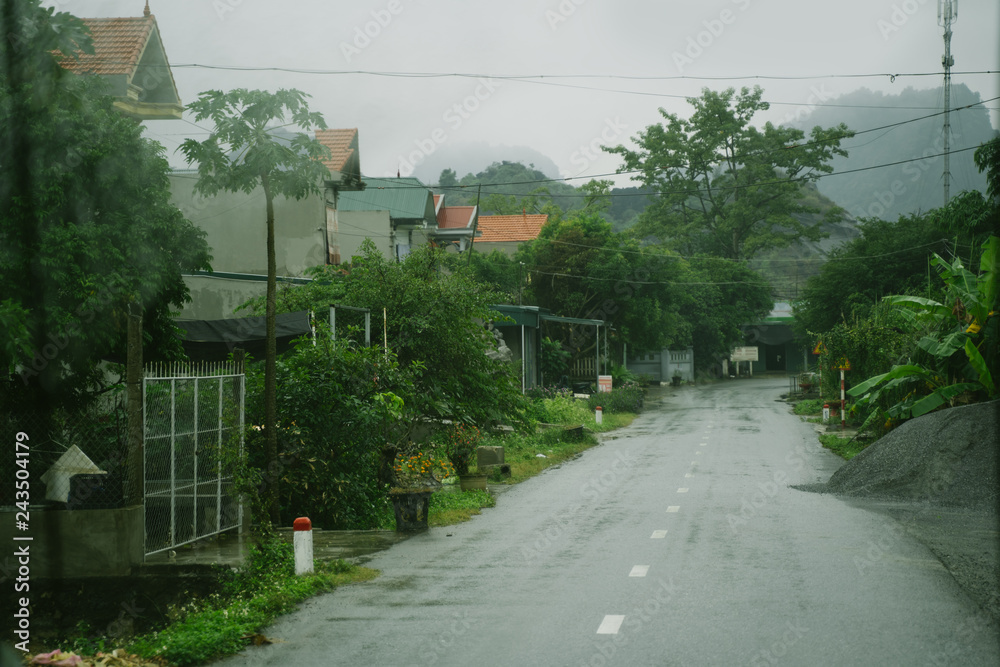 Vietnam countryside empty asphalt road in the village near green mountains