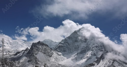 Snow Mountain Rock Peak with Moving clouds 4K Timelapse Video Nature Background abstract. Hiking Trekking Climbing Tourism to Everest in Nepal
