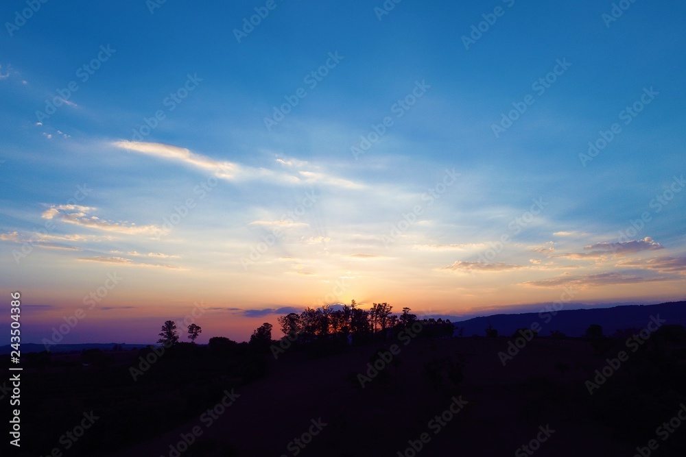 Fototapeta premium Aerial view of a sunset with beautiful sunbeams. Countryside view. Fantastic landscape. Great colors and contrast