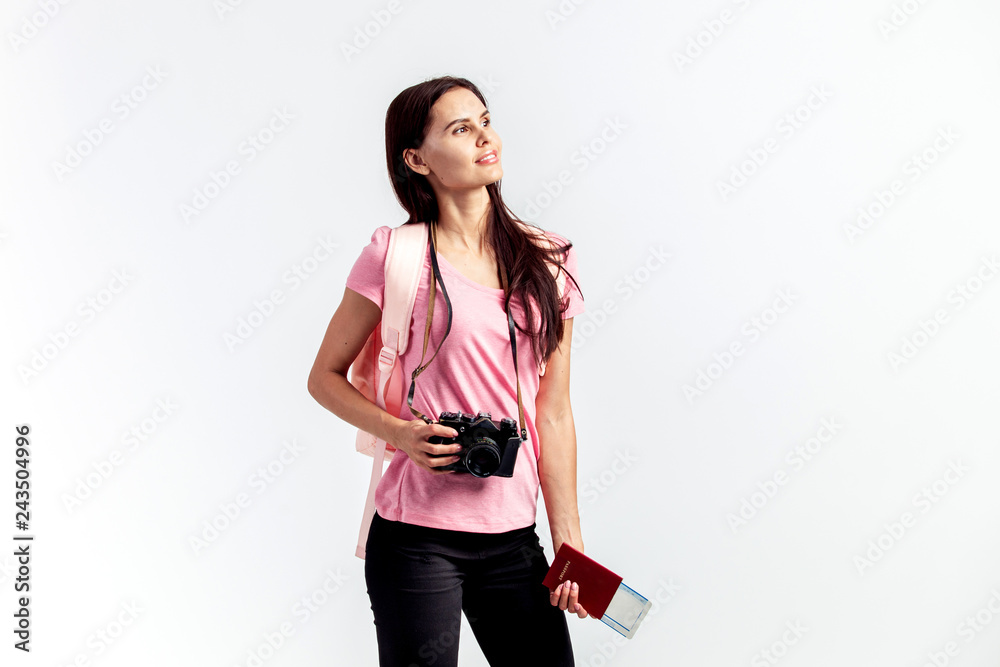 Happy girl with a backpack on her shoulders dressed in pink t-sh Happy girl with a backpack on her shoulders dressed in pink t-sh