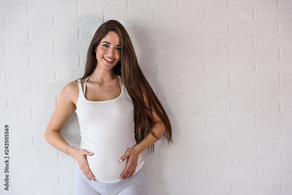 Portrait of happy smiling beautiful pregnant woman at home. Mother-to-be