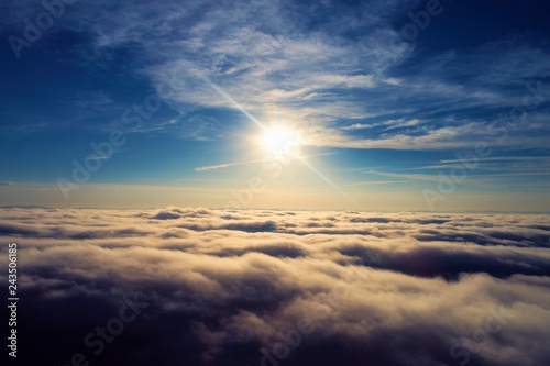 Sun over clouds with a blue sky. Fantastic landscape. Peace, Freedom, overcoming, God. Great sky view!