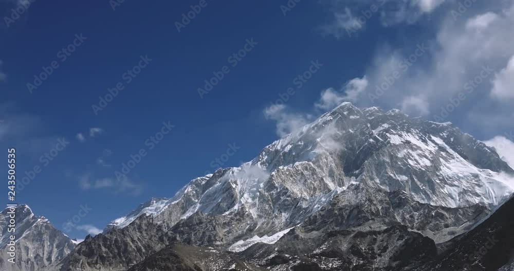 Snow Mountain Rock Peak with Moving clouds 4K Timelapse Video Nature Background abstract. Hiking Trekking Climbing Tourism to Everest in Nepal Snow Mountain Rock Peak with Moving clouds 4K Timelapse Video Nature Background abstract. Hiking Trekking Climbing Tourism to Everest in Nepal