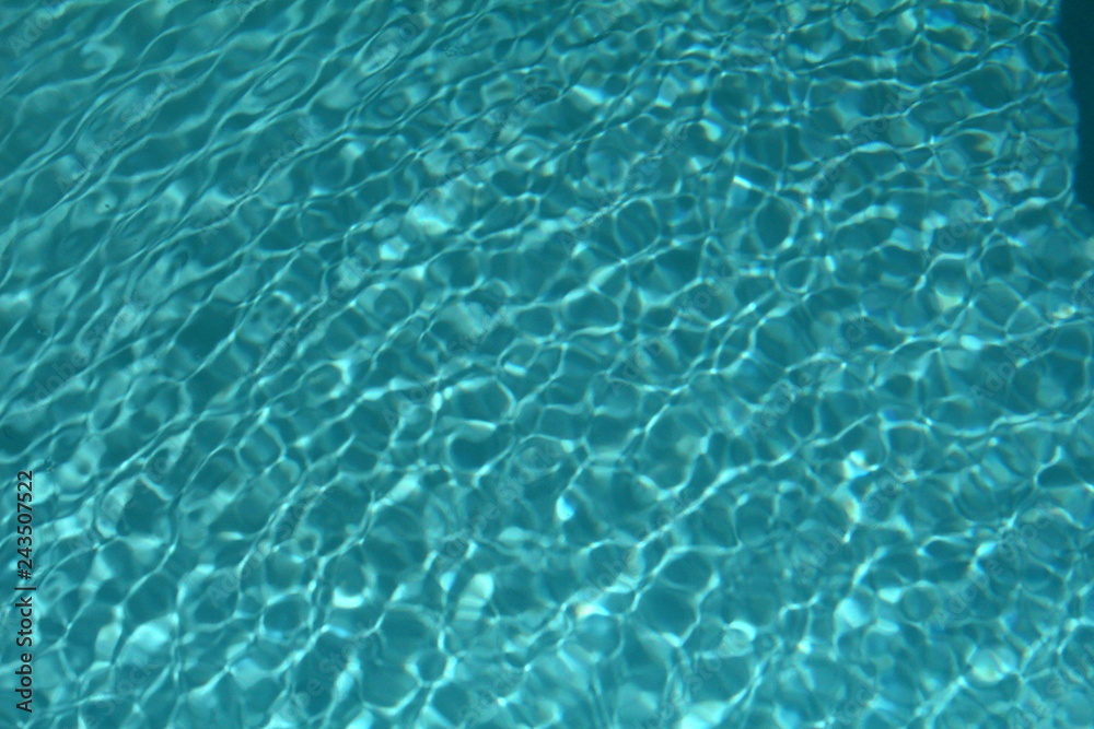 Textured water of a clean swimming pool makes an ideal  background for summer living.