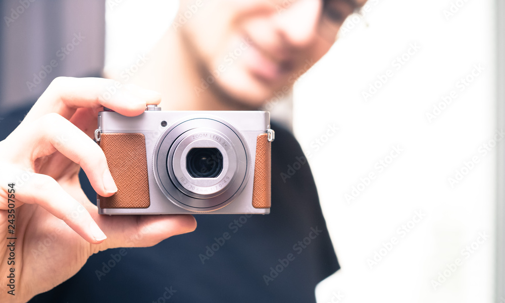 Young man takes a picture with a retro camera Young man takes a picture with a retro camera