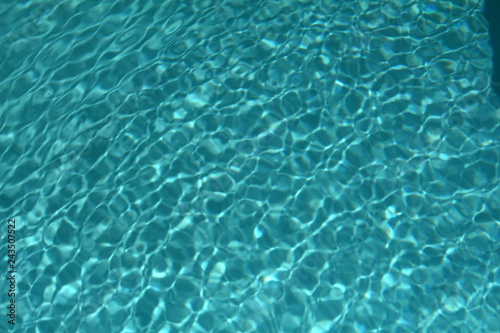 Textured water of a clean swimming pool makes an ideal background for summer living.