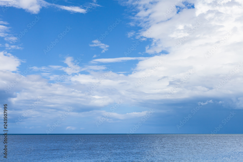 Seascape with blue water under cloudy sky