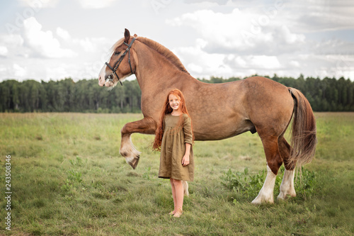 girl with horse in a field © Elena