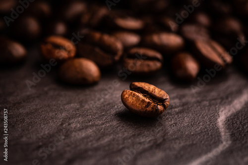 Coffee beans on a dark slate