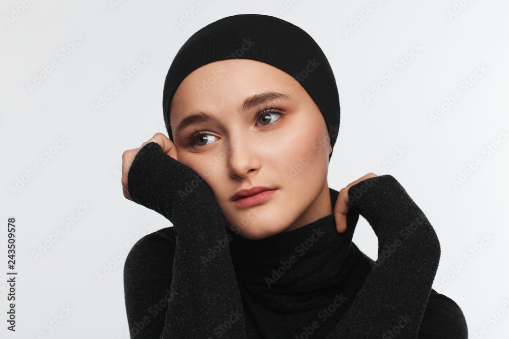 Portrait of a beautiful teenager girl in a black golf sweater and hat Portrait of a beautiful teenager girl in a black golf sweater and hat